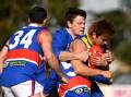 Daylesford's Tom Conroy and Riley White lay a crunching tackle on Learmonth ball magnet Will Green, under the watchful eye of Bulldogs teammate Matt Dean at Learmonth on Saturday. Picture by Adam Trafford.