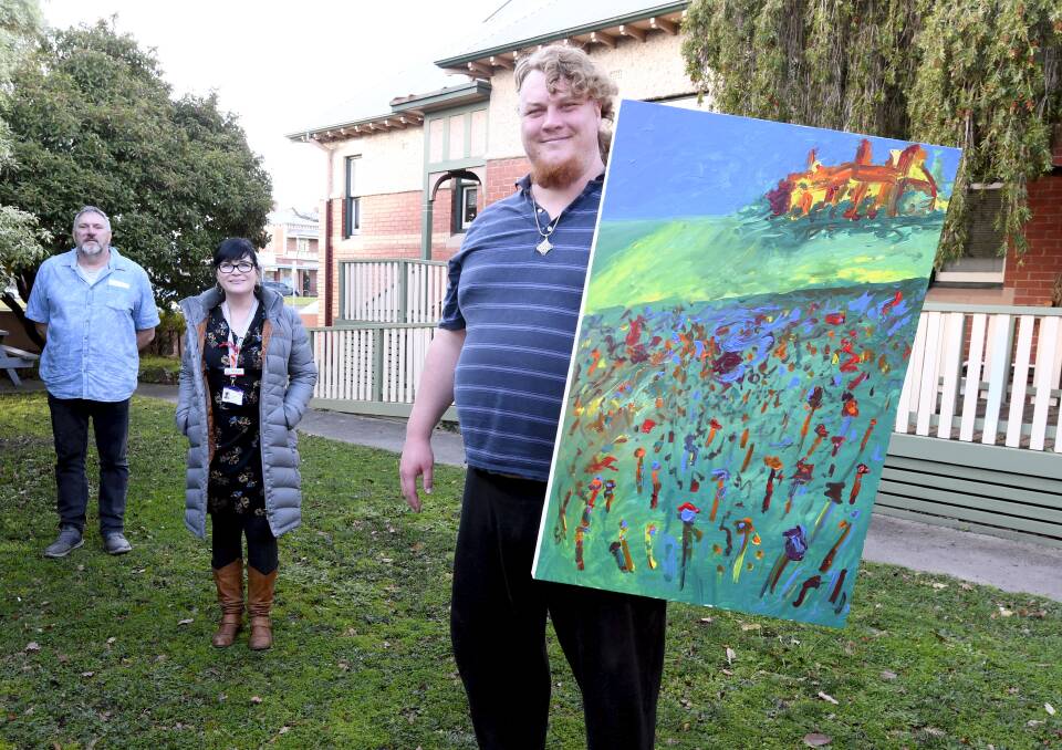 Get creative: Centacare's Paul Hartwood and BCH's Philippa Cane with artist David Holdaway. Picture: Lachlan Bence