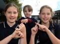 All pupils at St Francis Xavier Primary School including grade six students Matilda and Emma, and foundation student Jasper, are learning Auslan as a second language.Picture by Lachlan Bence