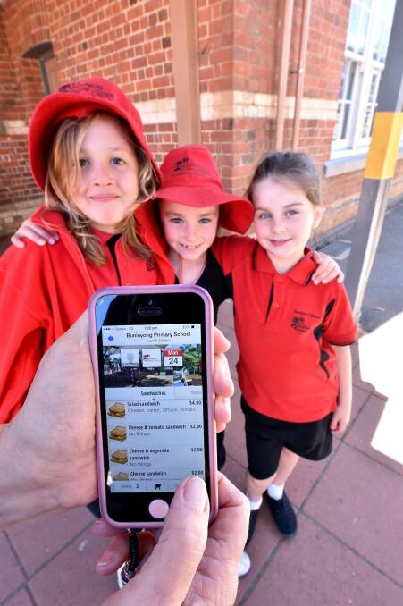 Buninyong Primary School pupils Sienna webb, Freya Palmer and Abby Thorn order their lunches on the school’s new app. PICTURE: JEREMY BANNISTER