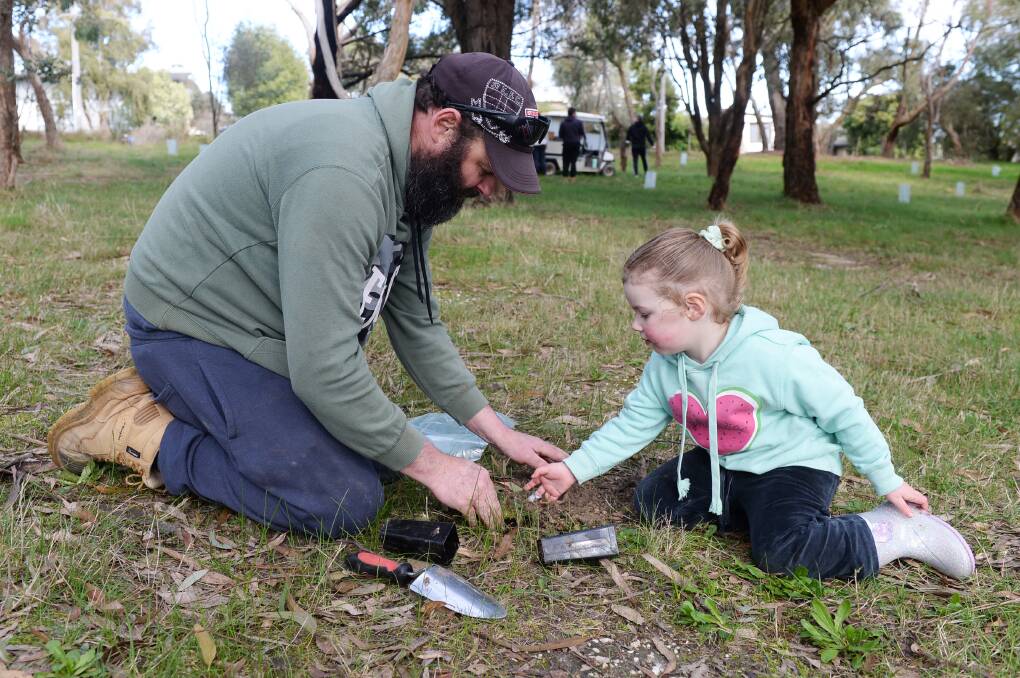 Shane Taylor along with his three-year-old daughter Mia planting a tree together for Ballarat Wildlife Park's koalas. Picture by Kate Healy