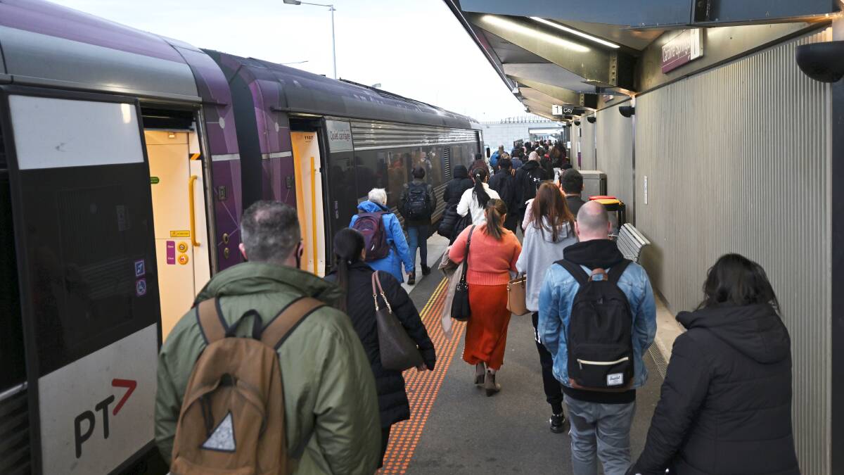 Commuters getting off the train at Caroline Springs to change to a bus service. Picture by Lachlan Bence