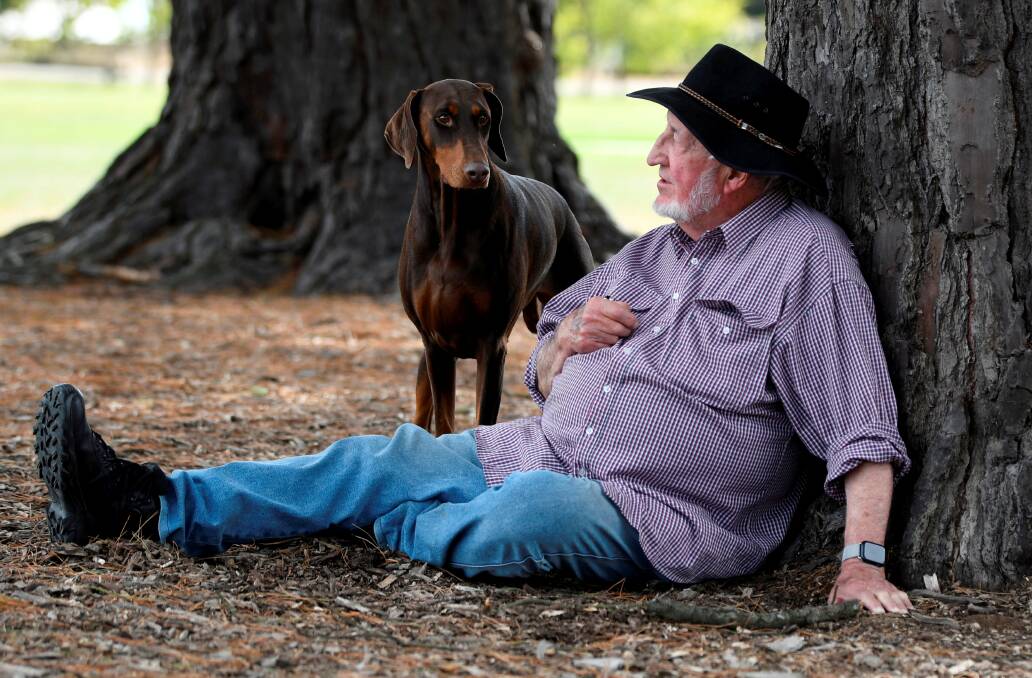 Dog trainer Ron Verso, 87, with his Dobermann Mia. Photo by Lachlan Bence.