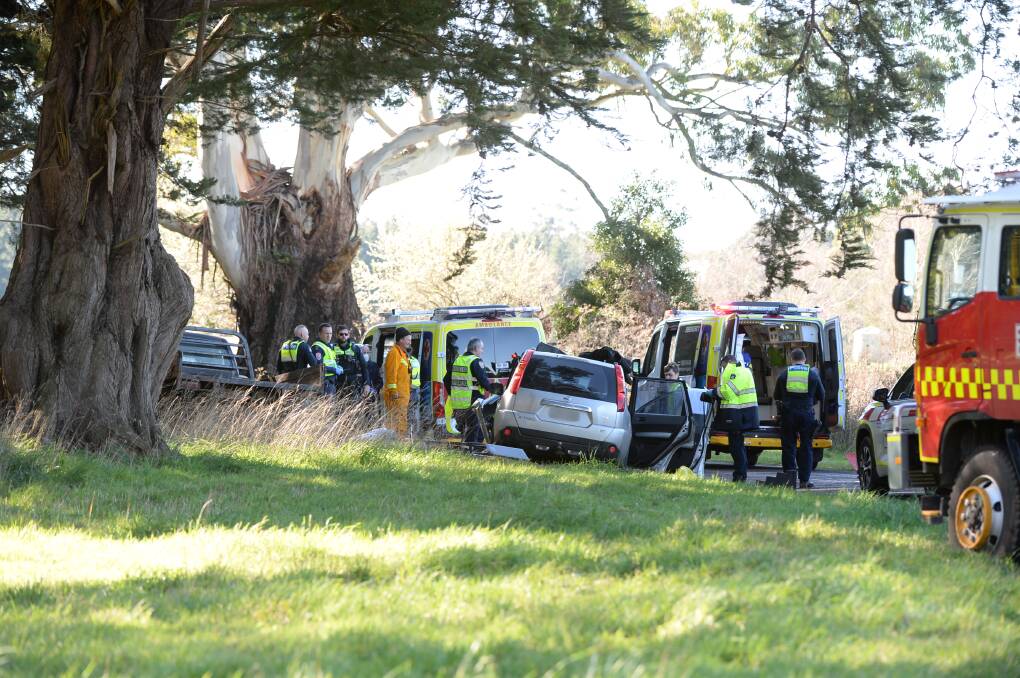 Emergency services attend to one of the vehicles involved in Thursday's crash. Picture by Kate Healy