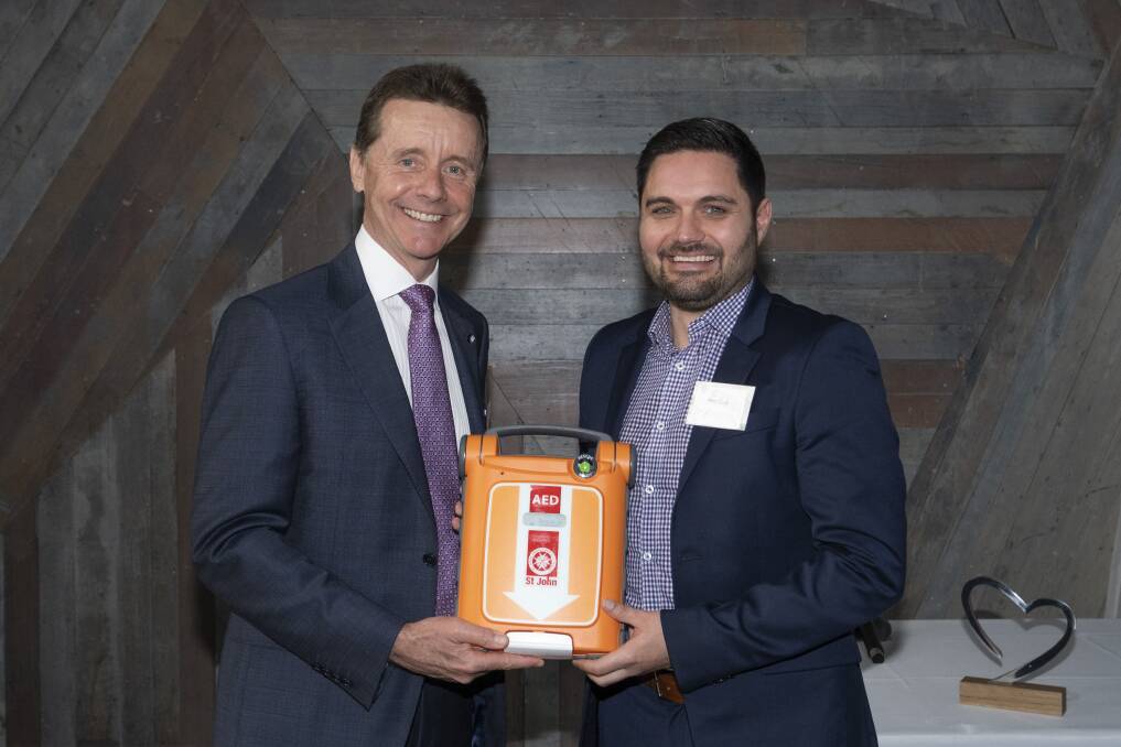 Matt Cash being presented the St John G5 Defibrillator by St John Victoria chair Mark Engel at the St John Ambulance Victoria Champions Awards on Wednesday. Picture supplied.