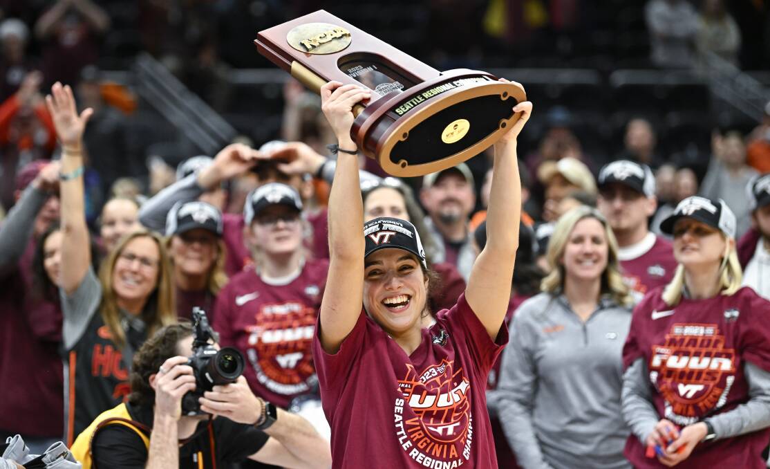 Ballarat Miners export Georgia Amoore lifts the Seattle Regional Championship trophy following Virginia Tech's Elite Eight triumph over Ohio State University. Pictures by Getty Images