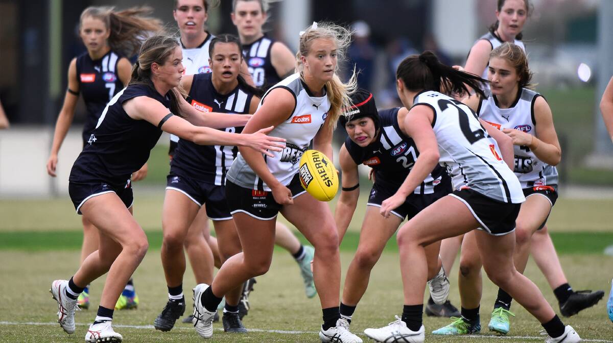 Paige Livingston of the GWV Rebels gets a handball away against Geelong. Picture by Adam Trafford
