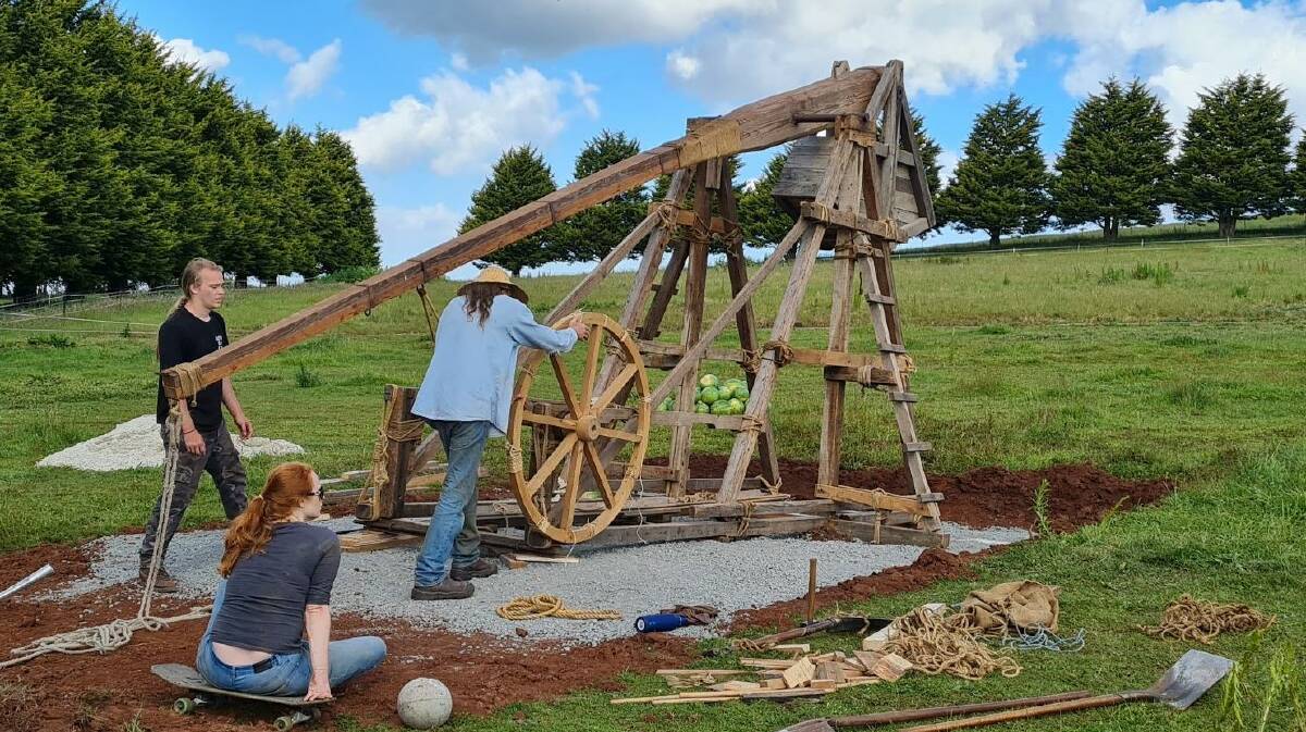 The giant catapult was made by Ballan man Craig Sitch (pictured with hat) who also makes armour for the re-enactment community. Picture by Gabrielle Hodson.
