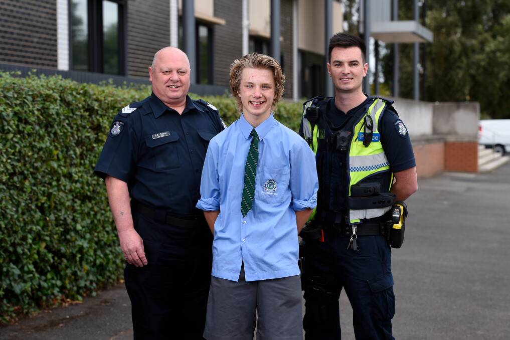 Riley Seccull 15 with Sergeant Chris Taylor (left) and Constable Jack Johnstone after he rescued an elderly man from a burning home in February 2020. Picture by Adam Trafford.