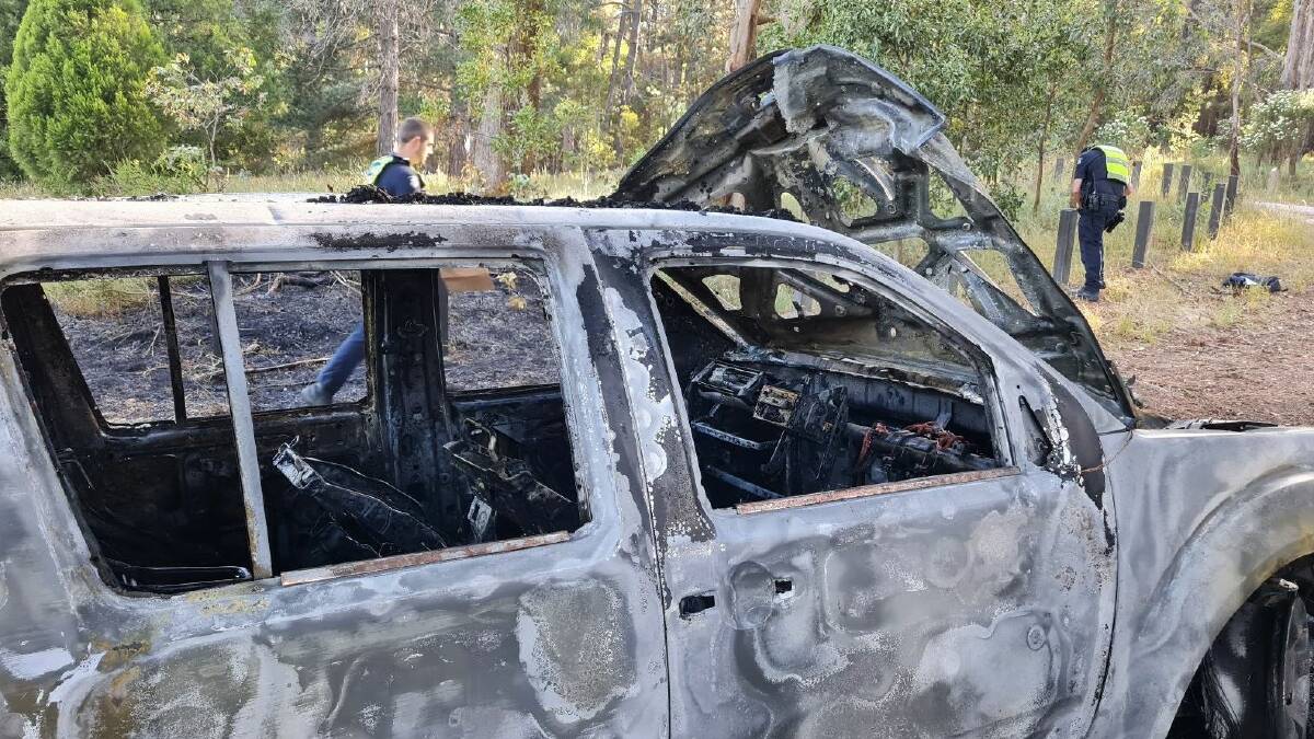 A stolen Nissan Pathfinder was destroyed in Wednesday's dawn blaze in Ballarat East. It also blackened nearby trees to a height of 7m and surrounding grass and bushes up to 6m away. Picture by Gabrielle Hodson.