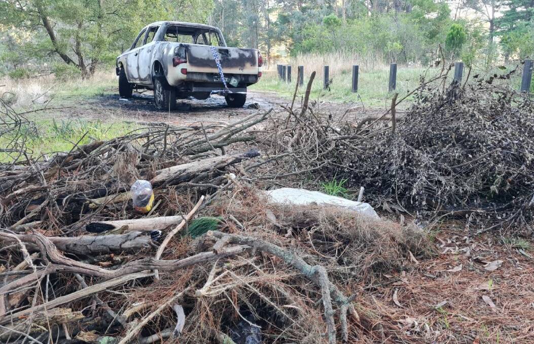 Piles of dead branches and rubbish were found nearby - including close to the front of Mitsubishi ute. Picture by Gabrielle Hodson.