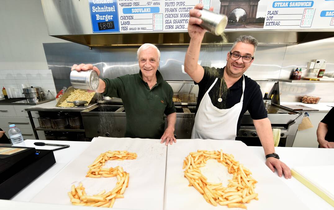 George Grinos with nephew and co-owner Andrew at Alfredton's Arch Fish Shop, celebrating 50 years of Grinos family ownership in 2021. Picture by Jeremy Bannister.