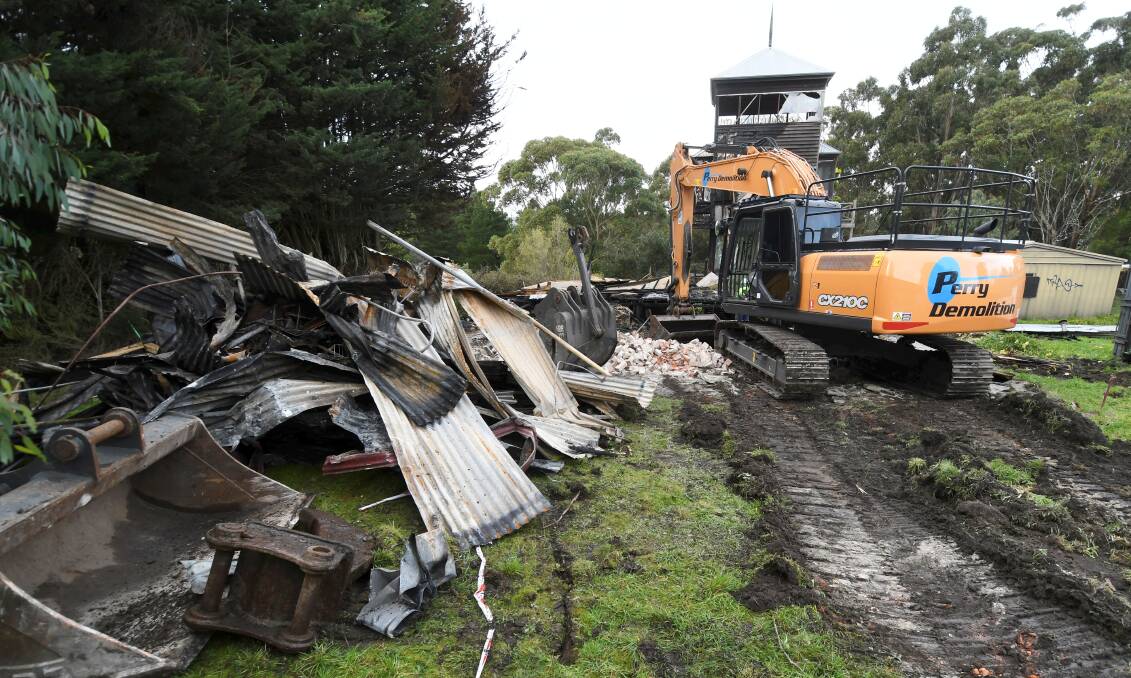 A bulldozer tore through John Pearce House on Tuesday. Pictures by Lachlan Bence