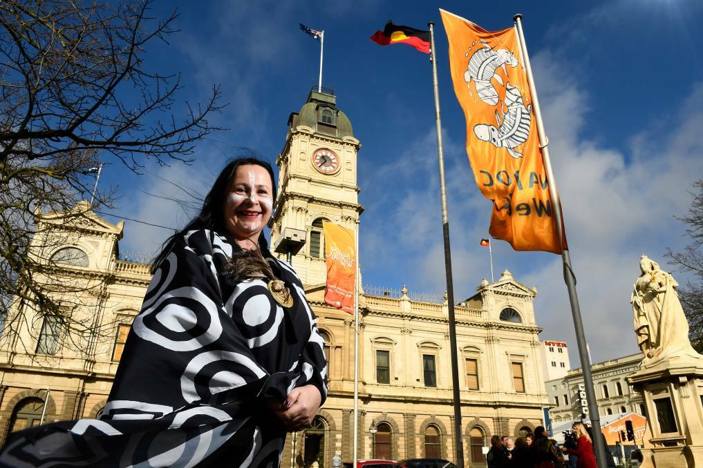 Queen Victoria's statue, right, overlooks Wadawurrung woman Deanne Gilson at an Aboriginal flag raising for 2019 NAIDOC Week. Picture by Adam Trafford.