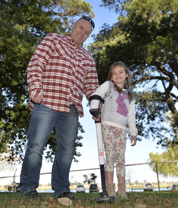 Treasure hunt: Michael Keen and his daughter Lily, 6, team up to try their luck at finding gold at Lake Wendouree. Picture: Dylan Burns