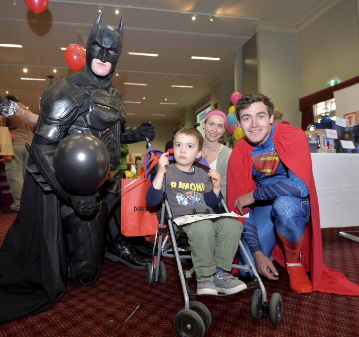 SUPER CAUSE: Superheroes Batman and Superman with Leo,4, and his mum Samantha Haintz. Picture: Dylan Burns