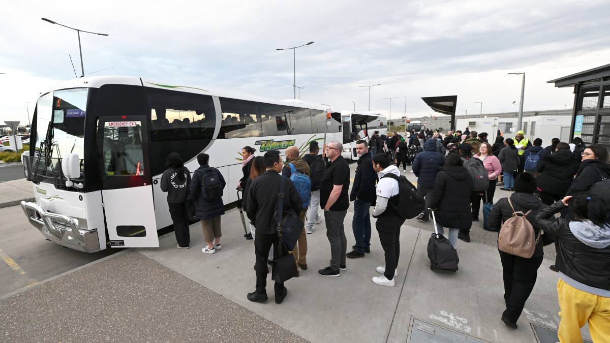 Crowds of commuters at Caroline Springs Station, awaiting buses to Southern Cross. Picture: Lachlan Bence. 