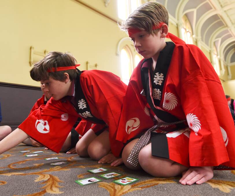 FOCUSED: St Alipius Parish School students Xavier, left, and Ryan play in the first Ballarat karuta tournament. Picture: Lachlan Bence