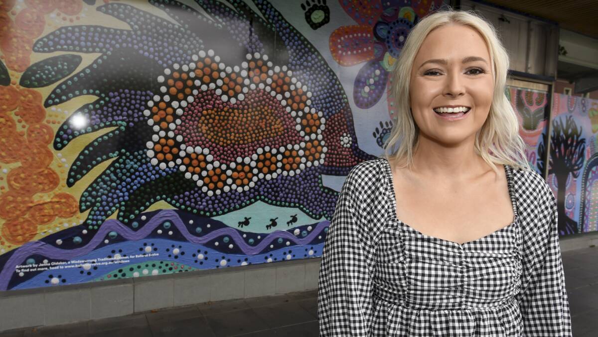 Wadawurrung traditional owner and artist Jenna Oldaker in front of her mural on a Norwich Plaza shopfront in the Bridge Mall. Picture by Lachlan Bence