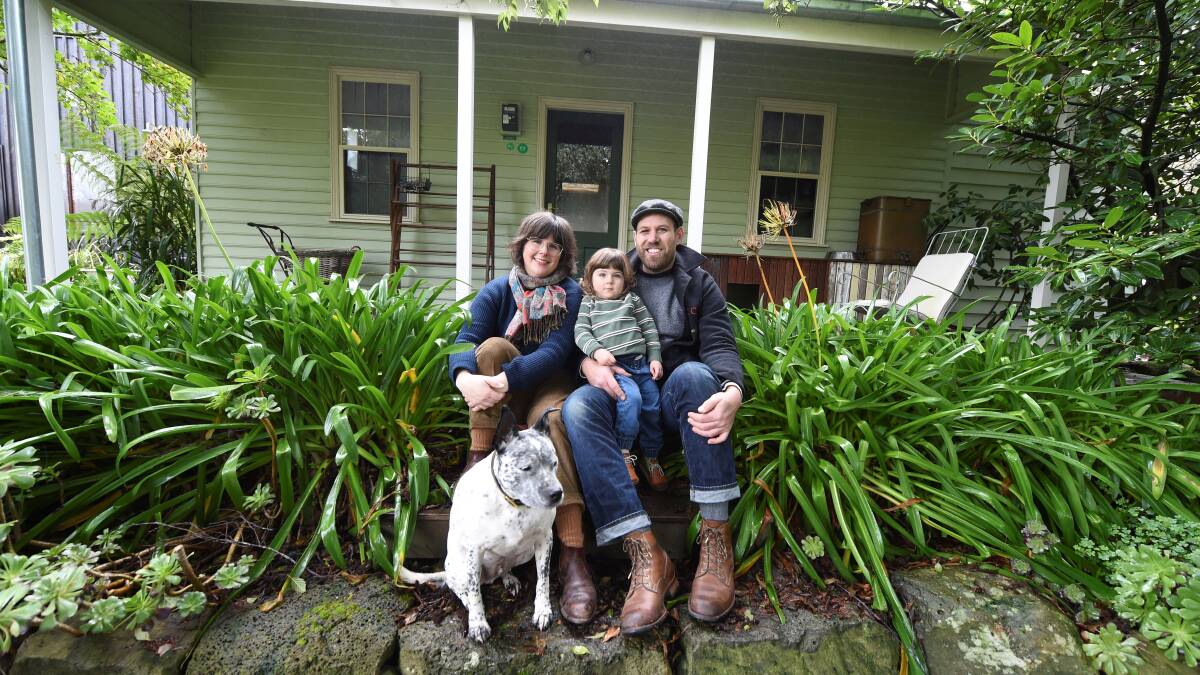 Krystina Menegazzo, Quincy Wootten, 2, and Jess Wootten with their dog Hunter outside the restored miners cottage in Gordon. Picture by Lachlan Bence