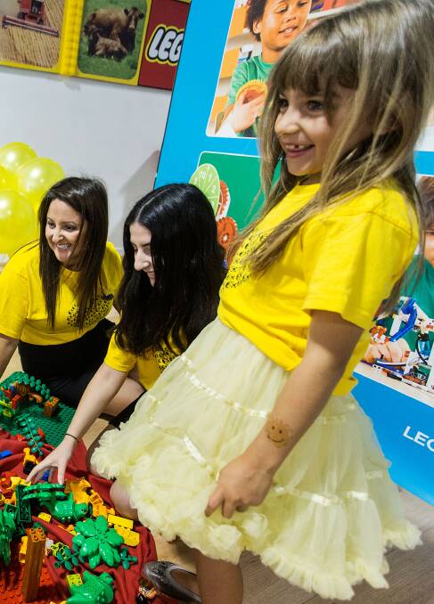 YELLOW PARTY: (from left) Yellow Ladybug Melbourne founder Katie Koullas, volunteer Leia Leventis and Mia Koullas enjoy a Ladybug party. Picture: Paul Jeffers