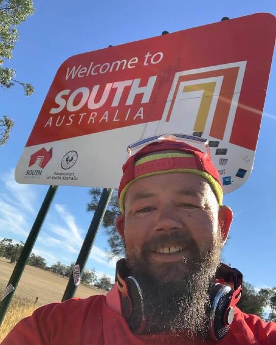 BIG STEP: Alan Thorpe reaches the South Australian border by foot early last week before aborting his mission due to extensive blistering. 