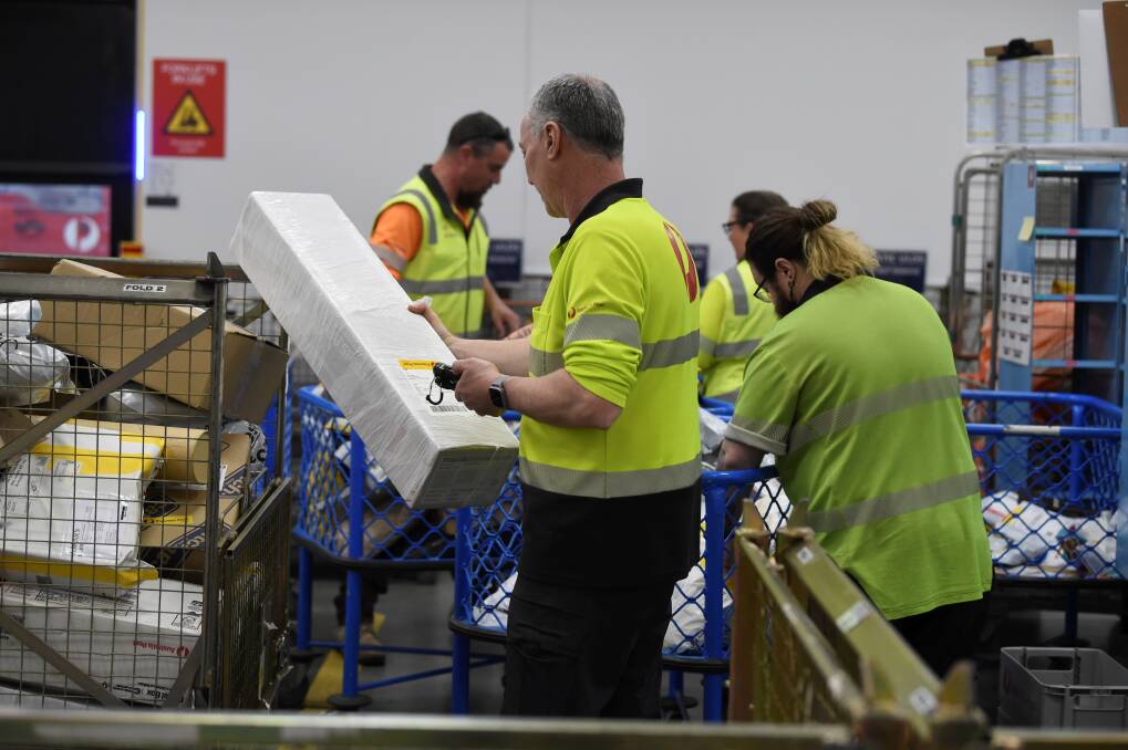All getting sorted with parcels checked for distribution by Australia Post staff.
