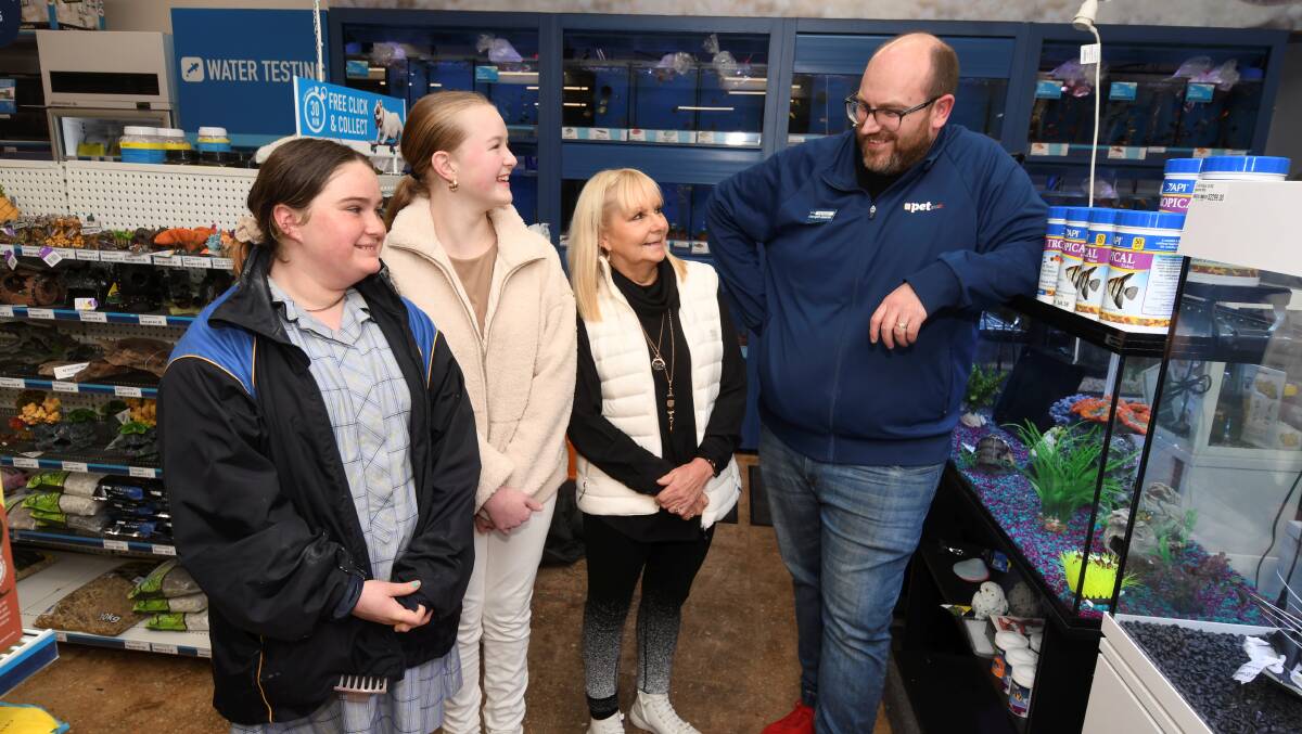 KIDS Foundation's Mady Hastings, Maggie Brown and chief executive Susie O'Neill visit the Mair Street store with Petstock's Patrick Passler on Tuesday. Picture by Lachlan Bence
