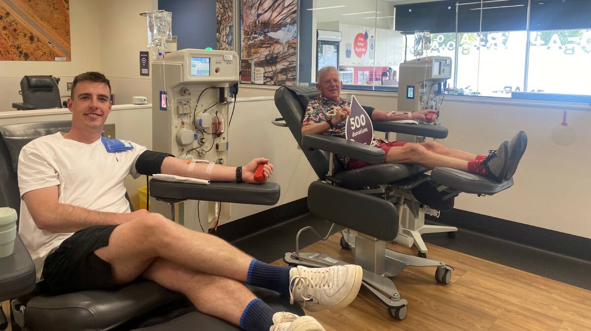 Ryan Walsh makes a donation alongside his dad Michael Walsh, who was making his 500th donation. Picture by Australian Red Cross Lifeblood
