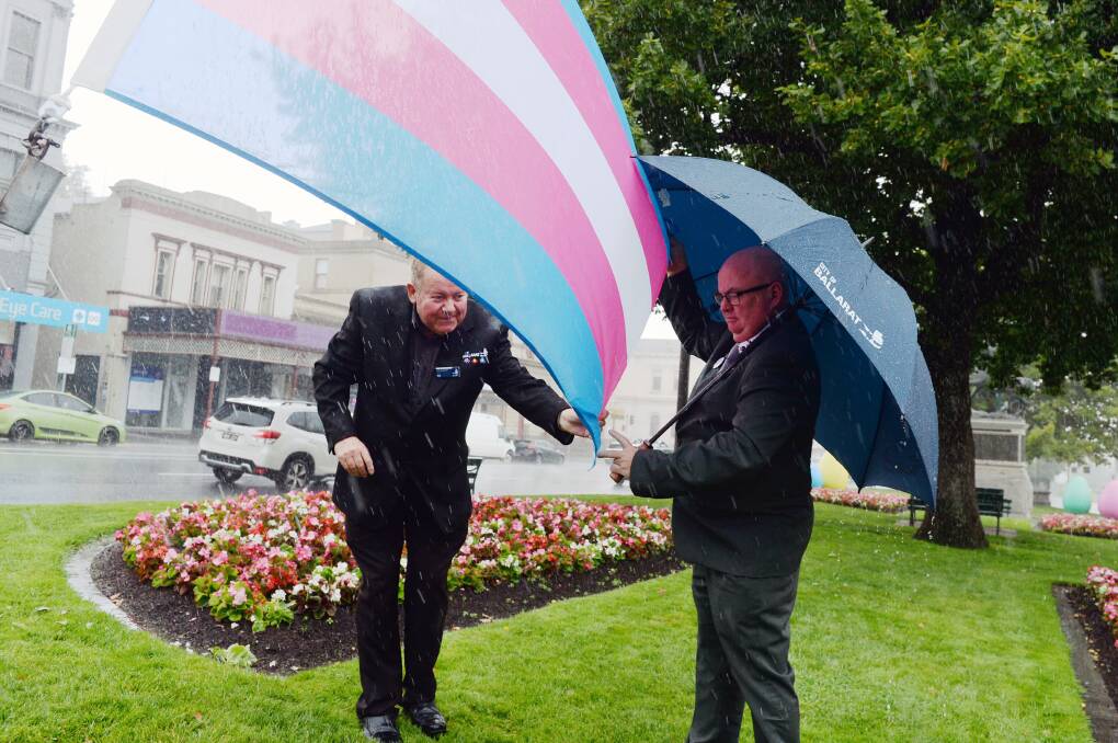 In all weather, Ballarat Town Hall keeper Rob McVitty was helping councillors, such as mayor Des Hudson, carry out their civic duties. Picture by Kate Healy