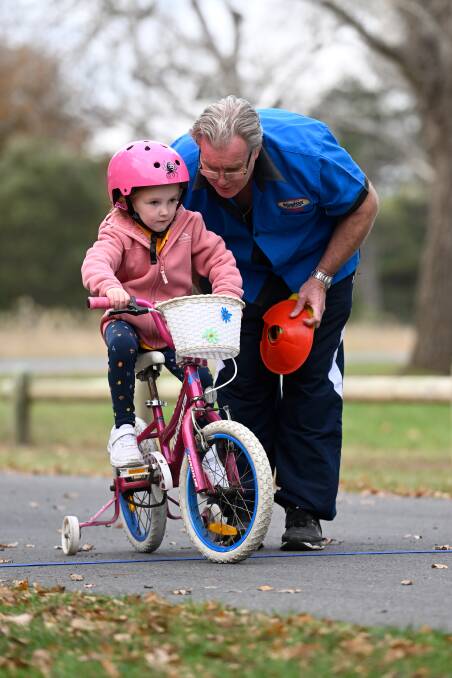 Ballarat-Sebstopol Cycling Club volunteer Chris Liston has been helping Hazel Mabilia finally learn to ride her bike in the Power2Pedal program in Victoria Park. Picture by Adam Trafford
