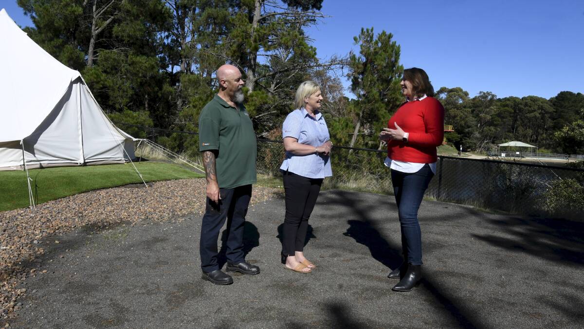 Creswick Holiday Park managers Stephen and Tammie Fisher show Ballarat MP Catherine King the view overlooking Lake Calembeen from a new glamping area on Friday. Picture by Lachlan Bence