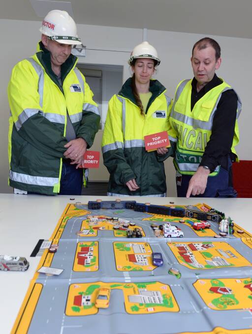BIG PICTURE: BHS director of emergency Andrew Crellin, nurse Patricia Flood and manger of emergency management Don Garlick map out a disaster response. Picture:  Kate Healy
