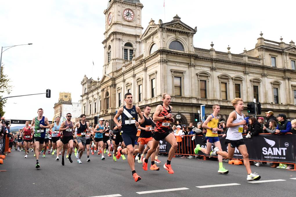 Tom Do Canto (in the blue), eventual winner of the Men's full marathon runs with Reece Edwards (in the orange and black), eventual winner of the half marathon. Picture by Adam Trafford