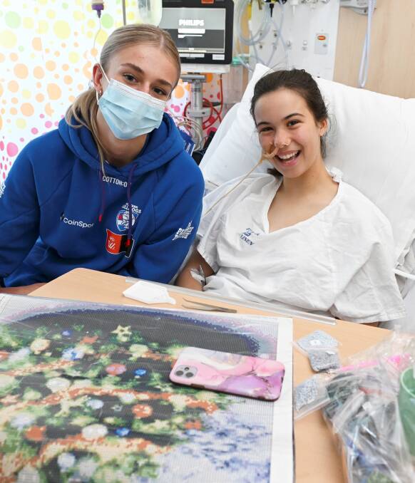AFLW footballer Kristie-Lee Weston-Turner says it is humbling to visit Ballarat children's ward while patient Isabella Ebenwaldner says she might start watching AFLW a bit more now. Picture by Lachlan Bence