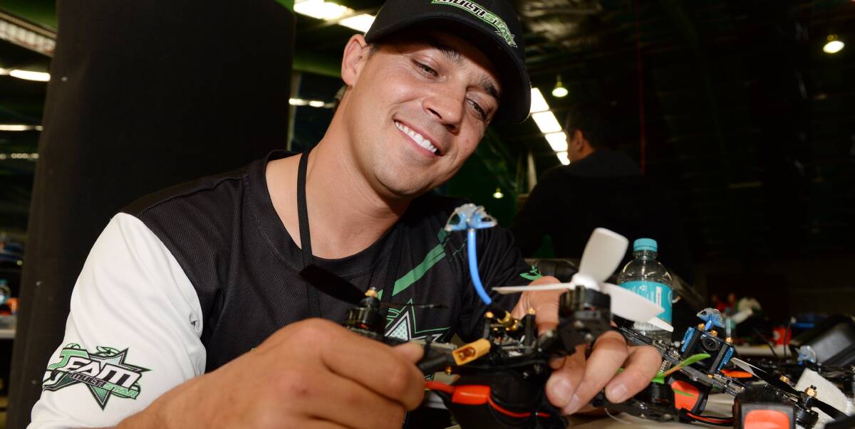 FINE-TUNE: American Shaun Taylor, better known by his codename Nytfury, tweaks his drone for speed racing in the Ballarat Exhibition Centre on Sunday. HIs next flying mission is in Sydney this week. Picture: Kate Healy
