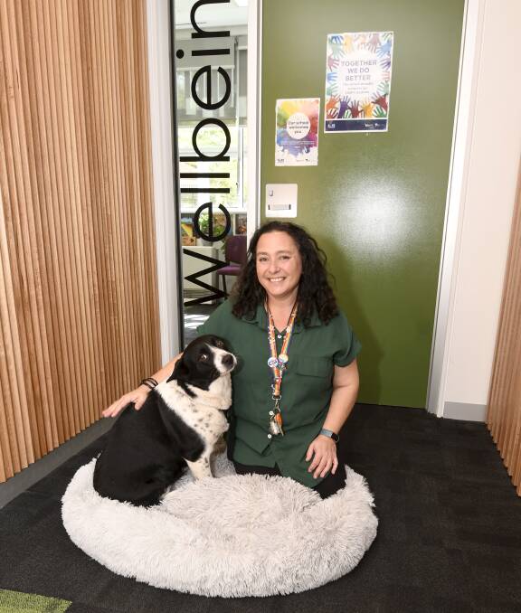 Ballarat High School youth consellor Shirlene Laurie with therapy dog Kai at the entrance to the school's new purpose-built well-being centre. Picture by Lachlan Bence