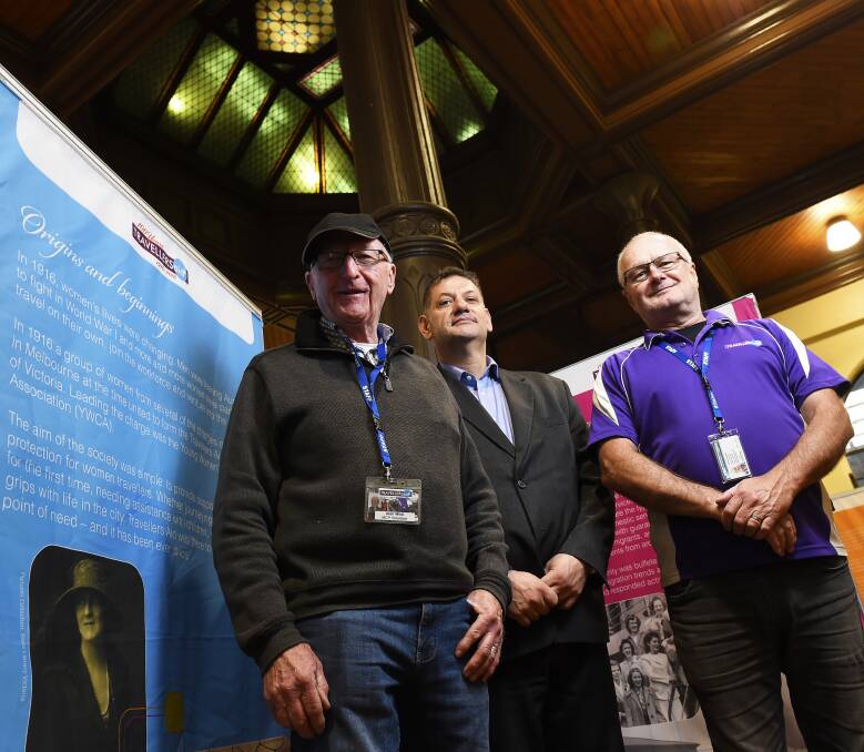 TRAVELLERS: Travellers Aid CEO Elias Lebbos (centre) with organisation volunteers Alan West (left) and Denis Campbell (right) inside the Ballarat Railway Station where the exhibition is located. Picture: Luka Kauzlaric