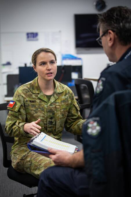 Australian Army Reserve Infantry Officer Lieutenant Eilish Hunt from 8th/7th Battalion Royal Victorian Regiment speaks with Victorian Police Senior Sergeant Paul Maslunka at the Police Assistance Line in Ballarat in support of Operation COVID 19 Assist. Picture: LAC John Solomon/Defence Media