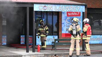 Firefighters at a laundromat on Macarthur Street. Picture by Lachlan Bence