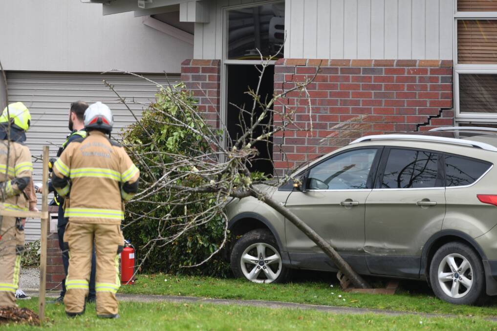 Police and firefighters check out the scene on Doveton Street North. Picture by Lachlan Bence