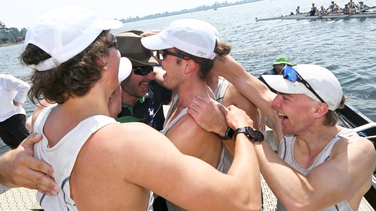 The St Patrick's crew celebrates with their coach after jumping off the boat. Picture by Lachlan Bence