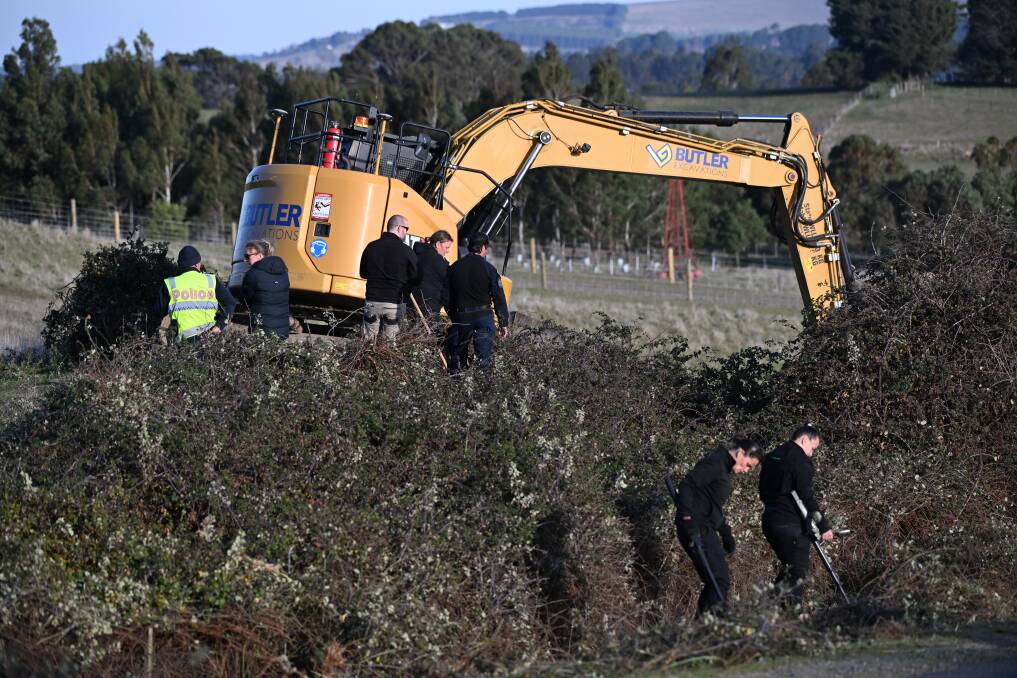 Police searching the area with an excavator. Picture by Lachlan Bence