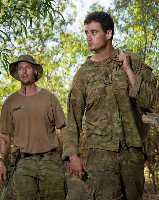 Roo stew: Australian Army officer Lieutenant David Hasler (right) and Australian Army soldier Sergeant Dominic Hamon walk back to their camp with a wallaby.