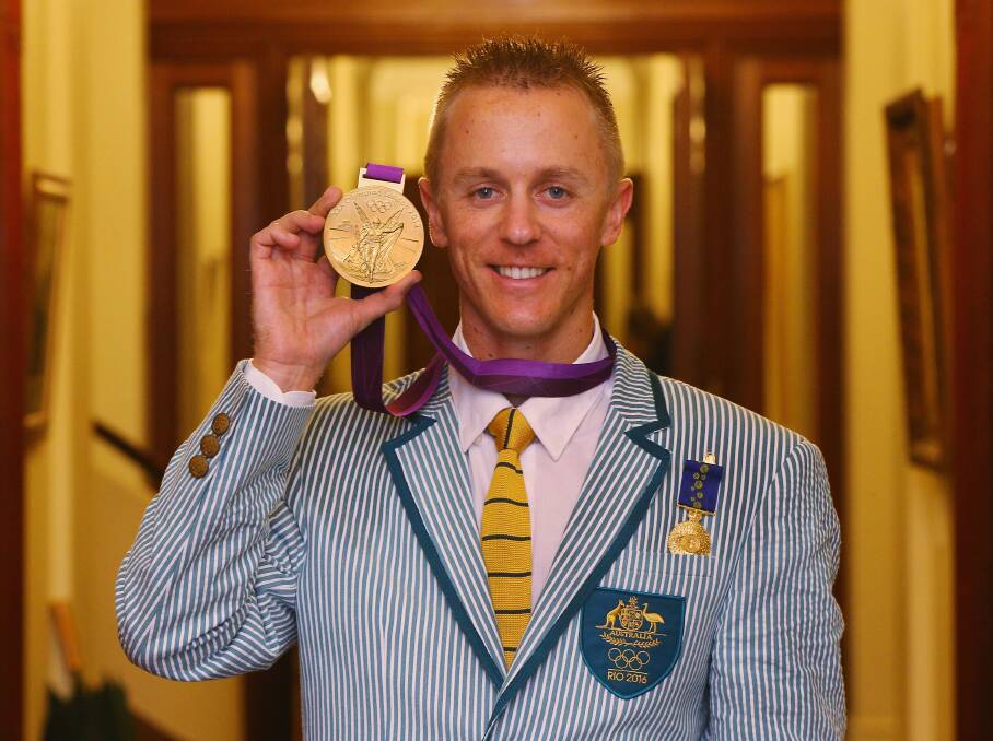 NOW IT'S MINE: Jared Tallent with his gold medal on Friday. Picture: Getty Images.