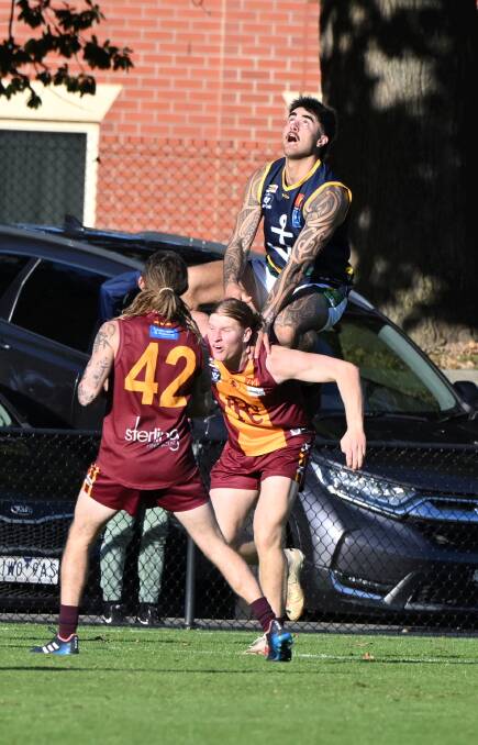 Jaydo Wright of Lake Wendouree climbs high in his team's clash with Redan. Picture by Lachlan Bence
