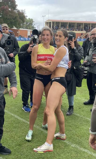 Grace O'Dwyer (white) congratulates winner Bella Pasquali after the Stawell Gift final. Picture by David Brehaut