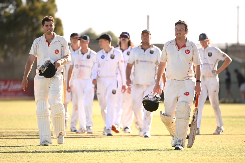 Jack Peeters (left) and Tom Batters lead the teams off the field after their thrilling last ball win on Saturday. Picture by Adam Trafford
