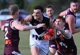 Max Scoble of Melton gets a don't argue from Simon McCartin or North Ballarat. Picture by Kate Healy