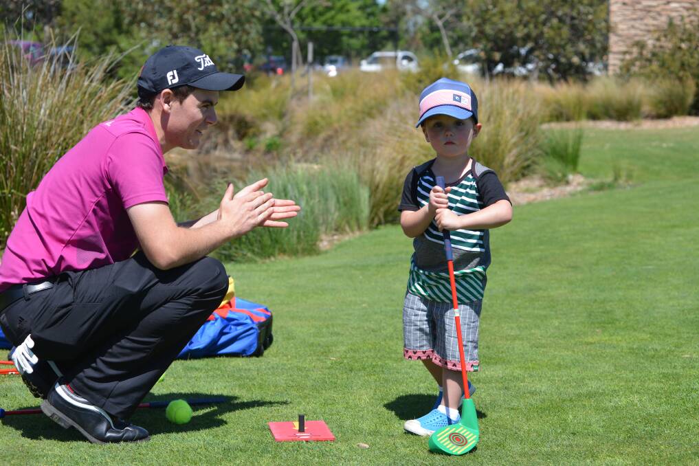 HELPING HAND: PGA Trainee Alex McKay with Flynn Illingworth.